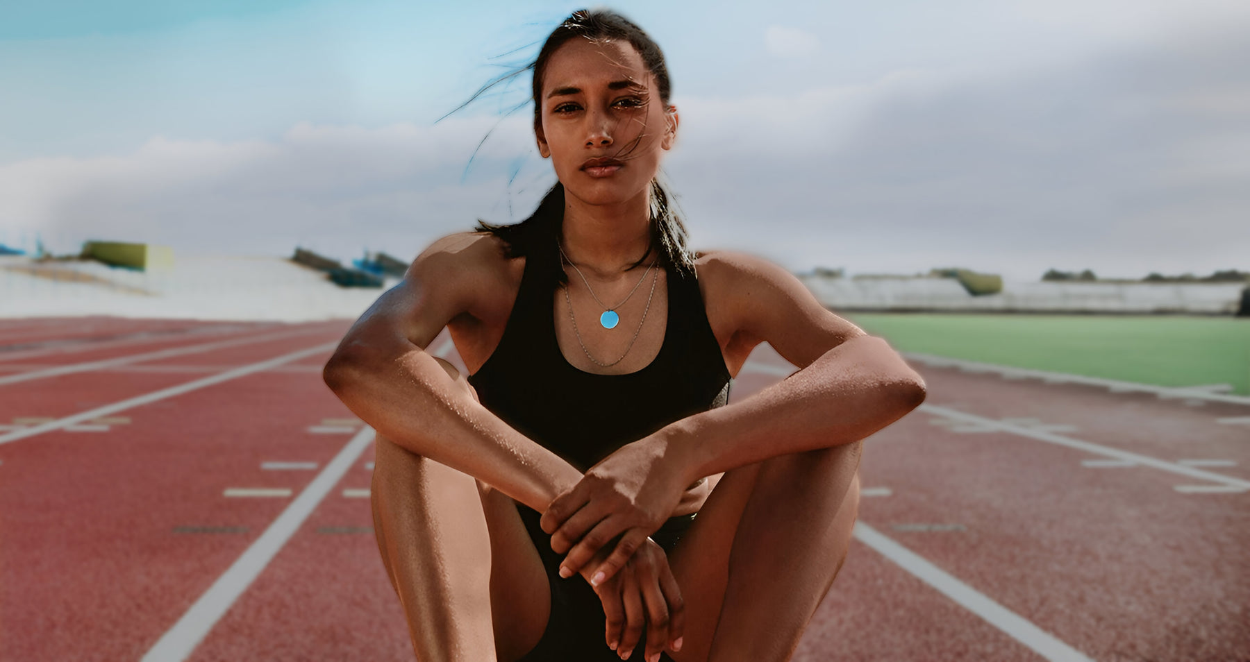 girl sitting on running track