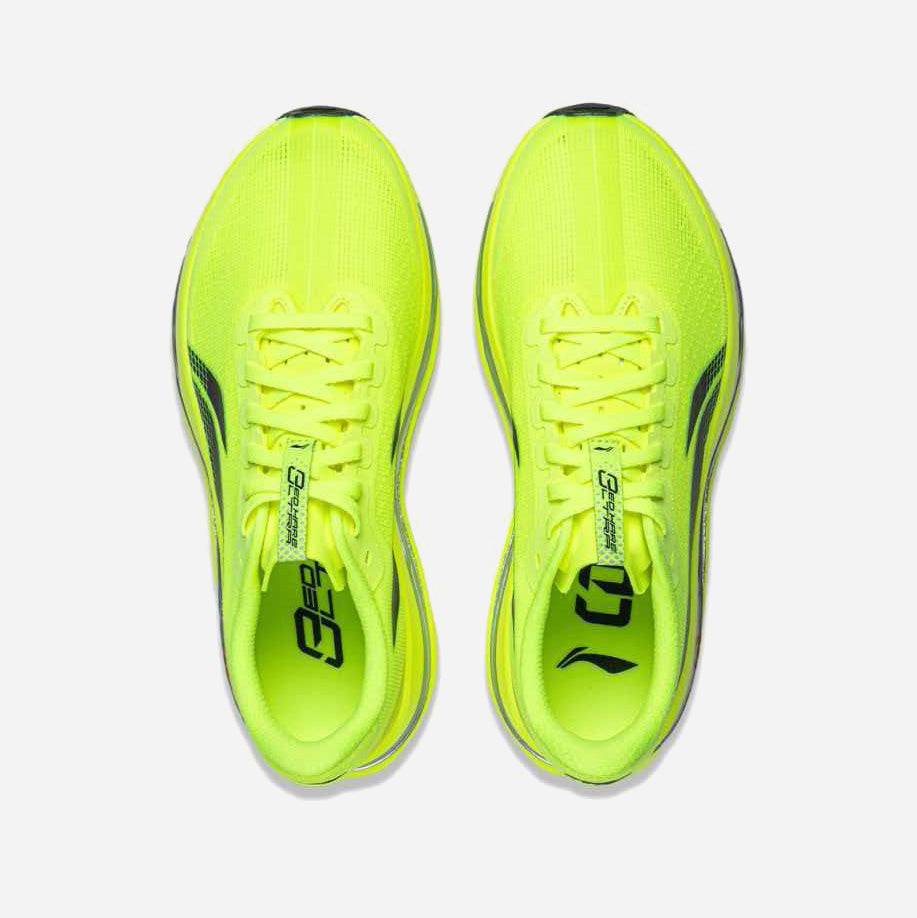 A pair of bright neon yellow running shoes shown from a top-down view on a light gray background.