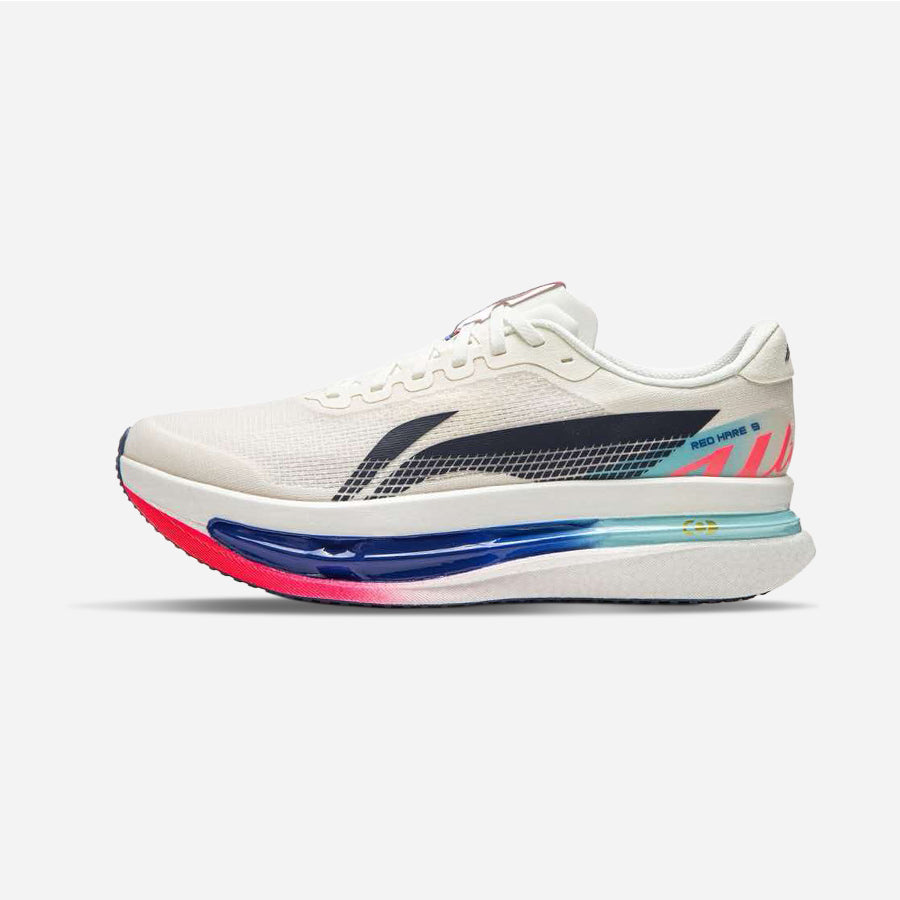 A white running shoe with a thick, colorful midsole featuring blue, pink, and light blue gradient sections, set against a plain light gray background.