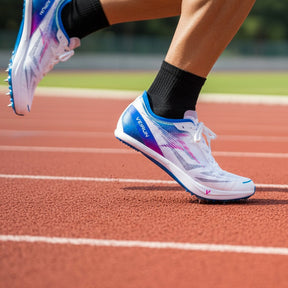 Person wearing white running shoes with blue and purple accents on a track